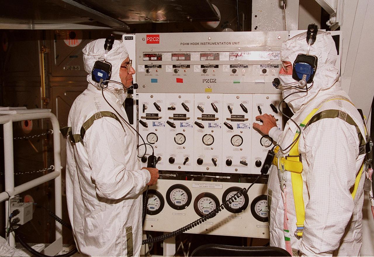 KENNEDY SPACE CENTER, FLA. -- In the Payload Changeout Room at Launch Pad 39A, technicians work the Payload Ground-Handling Mechanism hook instrumentation unit to move the U.S. Lab Destiny out of the payload canister and into the PCR. The Lab will then be transferred to the payload bay of Atlantis for mission STS-98. Destiny, a key element in the construction of the International Space Station is designed for space science experiments. STS-98 is the seventh construction flight to the ISS. Launch of STS-98 is scheduled for Jan. 19 at 2:11 a.m. EST