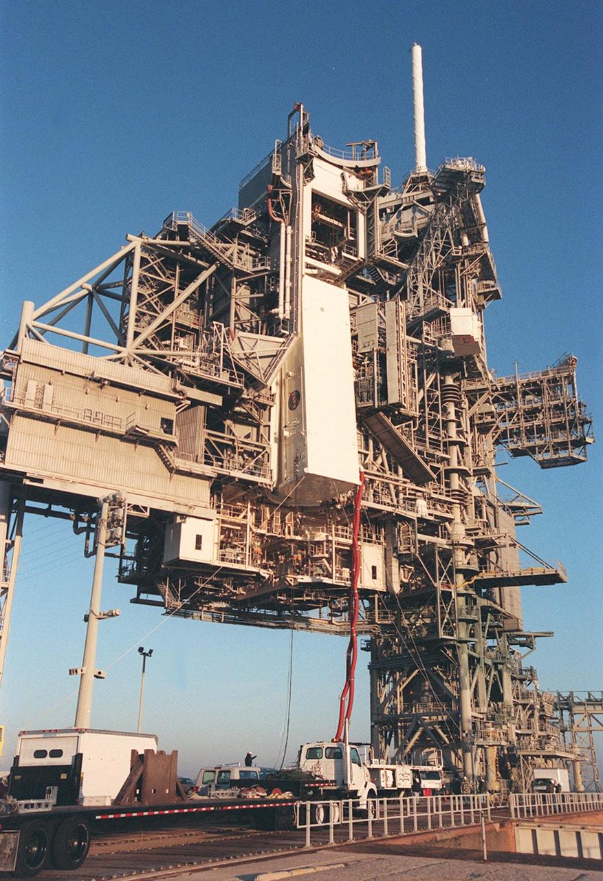 KENNEDY SPACE CENTER, FLA. -- The payload canister containing the U.S. Lab Destiny nears the payload changeout room on the Rotating Service Structure at Launch Pad 39A. Umbilical hoses are still attached. In the PCR Destiny will be removed and transferred to the payload bay of Atlantis for mission STS-98. Destiny, a key element in the construction of the International Space Station is designed for space science experiments. STS-98 is the seventh construction flight to the ISS. Launch of STS-98 is scheduled for Jan. 19 at 2:11 a.m. EST