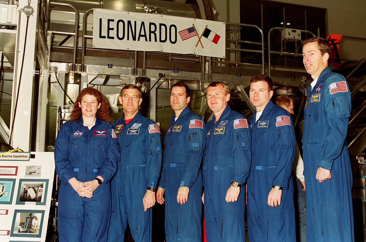 KENNEDY SPACE CENTER, FLA. -- The crew of STS-102, plus Expedition Two astronauts, poses in front of Leonardo, the Multi-Purpose Logistics Module that will fly on the mission. From left are Susan Helms and James Voss, part of Expedition Two; Mission Specialists Paul W. Richards and Andrew S.W. Thomas; Pilot James M. Kelly; and Commander James D. Wetherbee. Not shown is cosmonaut Yuri Usachev, who is also part of Expedition Two. The MPLM is the first of three such pressurized modules that will serve as the International Space Station’s “moving vans,” carrying laboratory racks filled with equipment, experiments and supplies to and from the Space Station aboard the Space Shuttle. Leonardo will be launched March 1, 2001, on Shuttle mission STS-102. On that flight, Leonardo will be filled with equipment and supplies to outfit the U.S. laboratory module Destiny. The mission will also be carrying the Expedition Two crew to the Space Station, replacing the Expedition One crew who will return on Shuttle Discovery