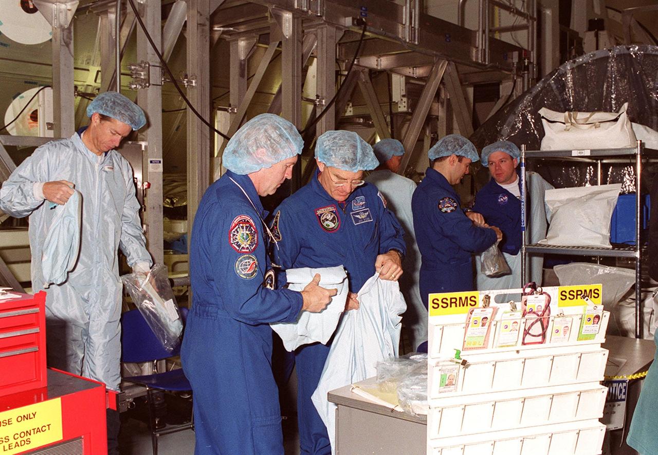 KENNEDY SPACE CENTER, FLA. -- In the Space Station Processing Facility, Multi-Purpose Logistics Module Leonardo has the attention of workers and some of the STS-102 crew. The MPLM, part of the payload on the STS-102 mission, is the first of three pressurized modules that will serve as the International Space Station’s “moving vans,” carrying laboratory racks filled with equipment, experiments and supplies to and from the Space Station aboard the Space Shuttle. Leonardo is scheduled to be launched in early March. On that flight, Leonardo will be filled with equipment and supplies to outfit the U.S. laboratory module Destiny. The mission will also be carrying the Expedition Two crew to the Space Station, replacing the Expedition One crew who will return on Shuttle Discovery
