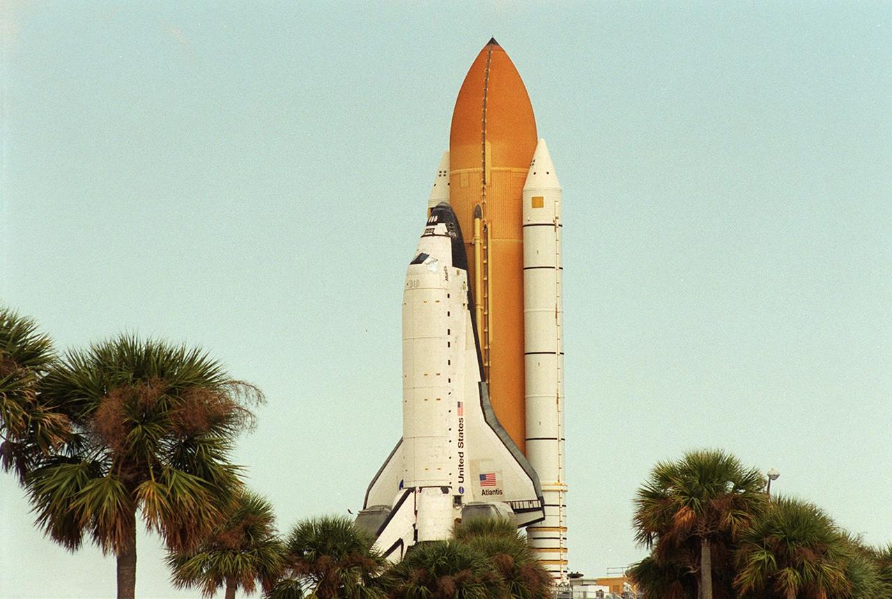 KENNEDY SPACE CENTER, FLA. -- Space Shuttle <a href="../../subjects/atlantis.htm"> Atlantis</a> moves past palm trees on its way back to the <a href="../../subjects/vab.htm"> Vehicle Assembly Building</a> from <a href="../../subjects/lc39a.htm"> Launch Pad 39A</a>. Atlantis is rolling back to the VAB from Launch Pad 39A. In the VAB workers will conduct inspections, make continuity checks and conduct X-ray analysis on the 36 solid rocket booster cables located inside each booster’s external system tunnel. An extensive evaluation of NASA’s SRB cable inventory revealed conductor damage in four (of about 200) cables on the shelf. Shuttle managers decided to prove the integrity of the system tunnel cables already on Atlantis before launching. The launch has been rescheduled no earlier than Feb. 6