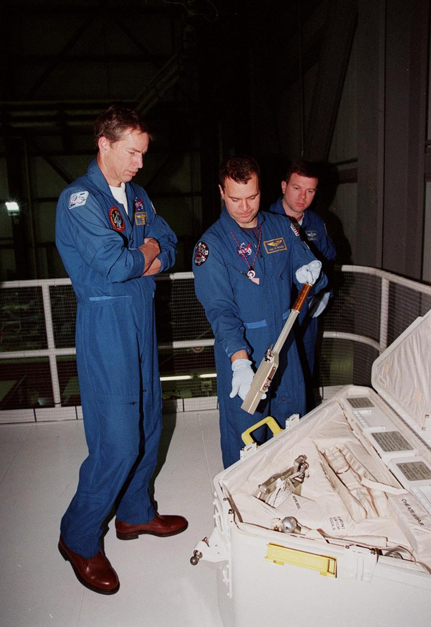In the Orbiter Processing Facility bay 1, STS-102 crew members check out tools in the tool caddy that is carried on launches. From left is Commander James D. Wetherbee, Mission Specialist Paul W. Richards and Pilot James W. Kelly. The mission crew is at KSC for Crew Equipment Interface Test activities