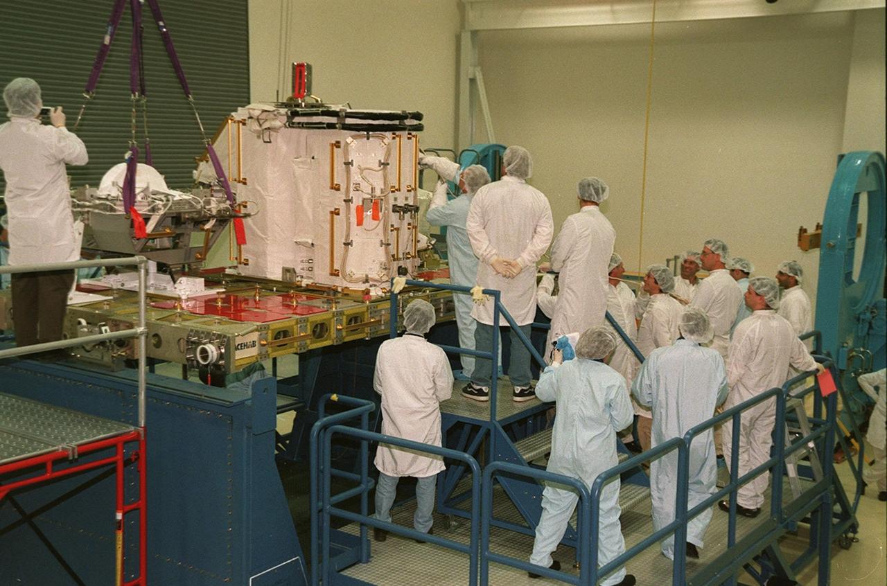 KENNEDY SPACE CENTER, FLA. -- Workers at SPACEHAB gather to watch STS-102 Mission Specialist Andrew S.W. Thomas work on the Early Ammonia Servicer. Thomas and other crew members are at SPACEHAB to get acquainted with tools and equipment they will be using on their mission to the International Space Station. The second spacewalk of the mission will require the crew to transfer the Early Ammonia Servicer to the P6 truss. STS-102 is the 8th construction flight to the International Space Station and will carry the Multi-Purpose Logistics Module Leonardo. On that flight, Leonardo will be filled with equipment and supplies to outfit the U.S. laboratory module Destiny. The mission will also be carrying the Expedition Two crew to the Space Station, replacing the Expedition One crew who will return on Shuttle Discovery. STS-102 is scheduled for launch March 8, 2001