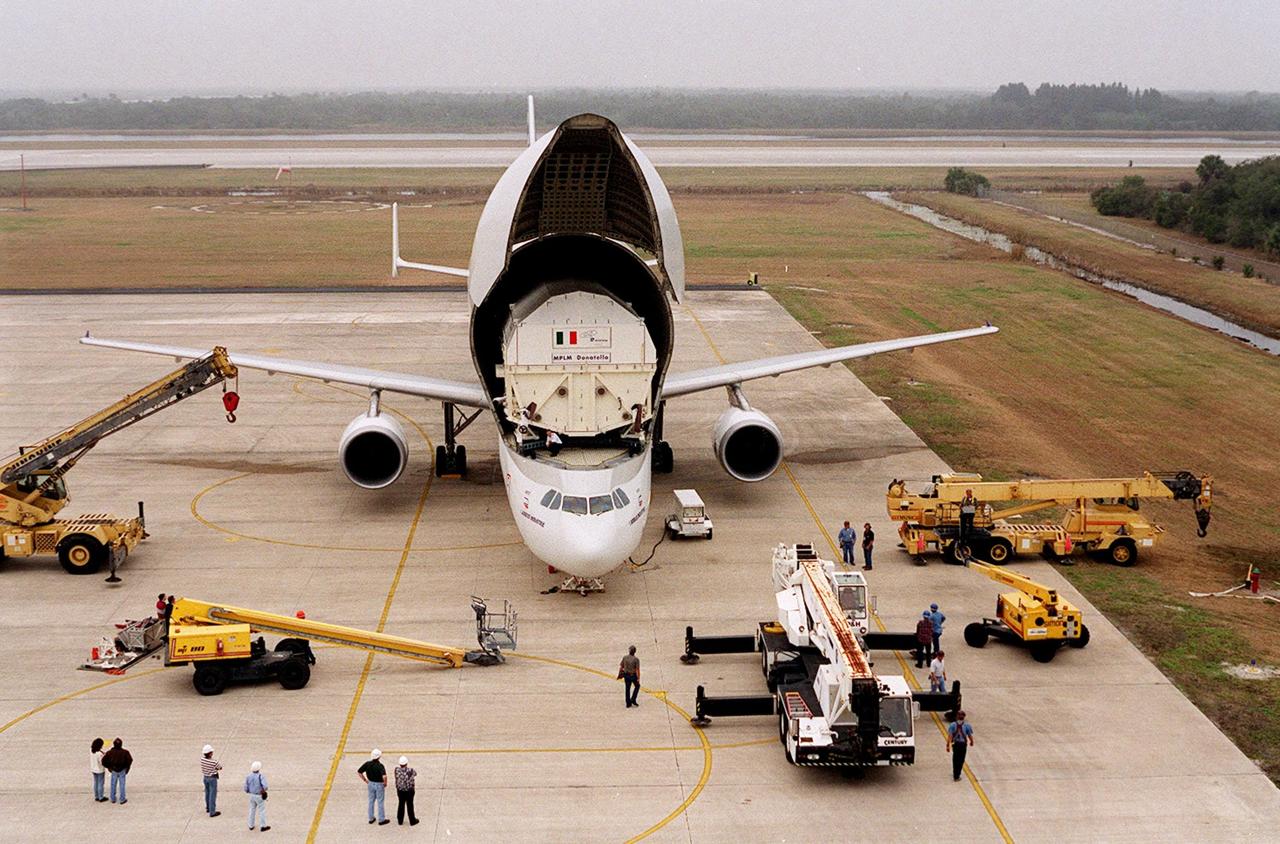 At the KSC <a href="../../subjects/slf.htm"> Shuttle Landing Facility</a>, an Airbus “Beluga” air cargo plane opens to reveal its cargo, the Italian Space Agency’s <a href="../../subjects/mplm.htm"> Multi-Purpose Logistics Module</a> Donatello, from the factory of Alenia Aerospazio in Turin, Italy. The third of three for the International Space Station, the module will be transported to the <a href="../../subjects/sspf.htm"> Space Station Processing Facility</a> for processing. Among the activities for the payload test team are integrated electrical tests with other Station elements in the SSPF, leak tests, electrical and software compatibility tests with the Space Shuttle (using the Cargo Integrated Test equipment) and an Interface Verification Test once the module is installed in the Space Shuttle’s payload bay at the launch pad. The most significant mechanical task to be performed on Donatello in the SSPF is the installation and outfitting of the racks for carrying the various experiments and cargo