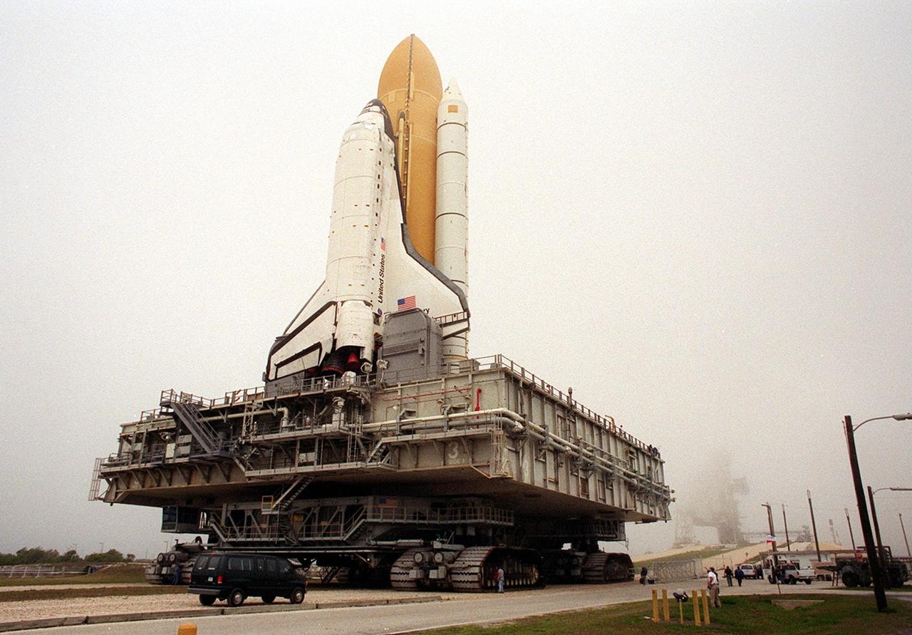 KENNEDY SPACE CENTER, Fla. -- Space Shuttle Discovery nears the ramp to the top of Launch Pad 39B. The early morning fog that had cleared for the rollout can be seen rolling back over the pad. Discovery will be flying on mission STS-102 to the International Space Station. Its payload is the Multi-Purpose Logistics Module Leonardo, a “moving van,” to carry laboratory racks filled with equipment, experiments and supplies to and from the Space Station aboard the Space Shuttle. The flight will also carry the Expedition Two crew up to the Space Station, replacing Expedition One, who will return to Earth on Discovery. Launch is scheduled for March 8 at 6:45 a.m. EST