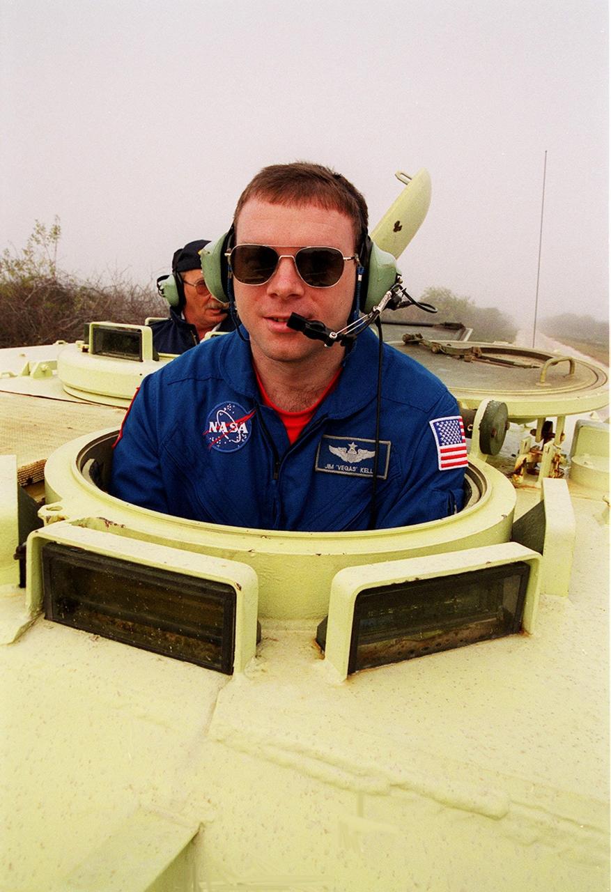 STS-102 Pilot James Kelly gets into the driver’s seat of an M-113 armored carrier near Launch Pad 39B he will practice driving. In the background is Capt. George Hoggard, a training officer with SGS Fire Services. In the event of an emergency at the pad prior to launch, the carrier could be used to transport the crew to a nearby bunker or farther. The STS-102 crew is at KSC to take part in Terminal Countdown Demonstration Test activities, which also include a simulated launch countdown. STS-102 is the eighth construction flight to the International Space Station, carrying as payload the Multi-Purpose Logistics Module Leonardo. Launch on mission STS-102 is scheduled for March 8