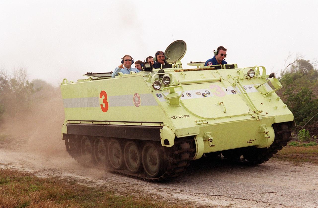 STS-102 Pilot James Kelly takes his turn driving the M-113 armored carrier that the crew could use to exit the pad if an emergency ever occurred prior to launch. Behind him are other members of the crew and training officers. The STS-102 crew is at KSC to take part in Terminal Countdown Demonstration Test activities, which also include a simulated launch countdown. STS-102 is the eighth construction flight to the International Space Station, carrying as payload the Multi-Purpose Logistics Module Leonardo. Launch on mission STS-102 is scheduled for March 8