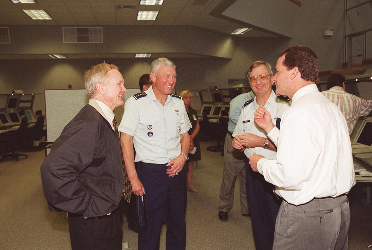 Inside the new firing room at the Launch Control Center, Center Director Roy Bridges, Gen. Ralph Everhart and Brig. Gen. Donald Pettit listen to Director of Shuttle Processing Dave King as he relates a story. Gen. Everhart is Commander of Space Command and Gen. Pettit is Commander of the 45th Space Wing, Cape Canaveral