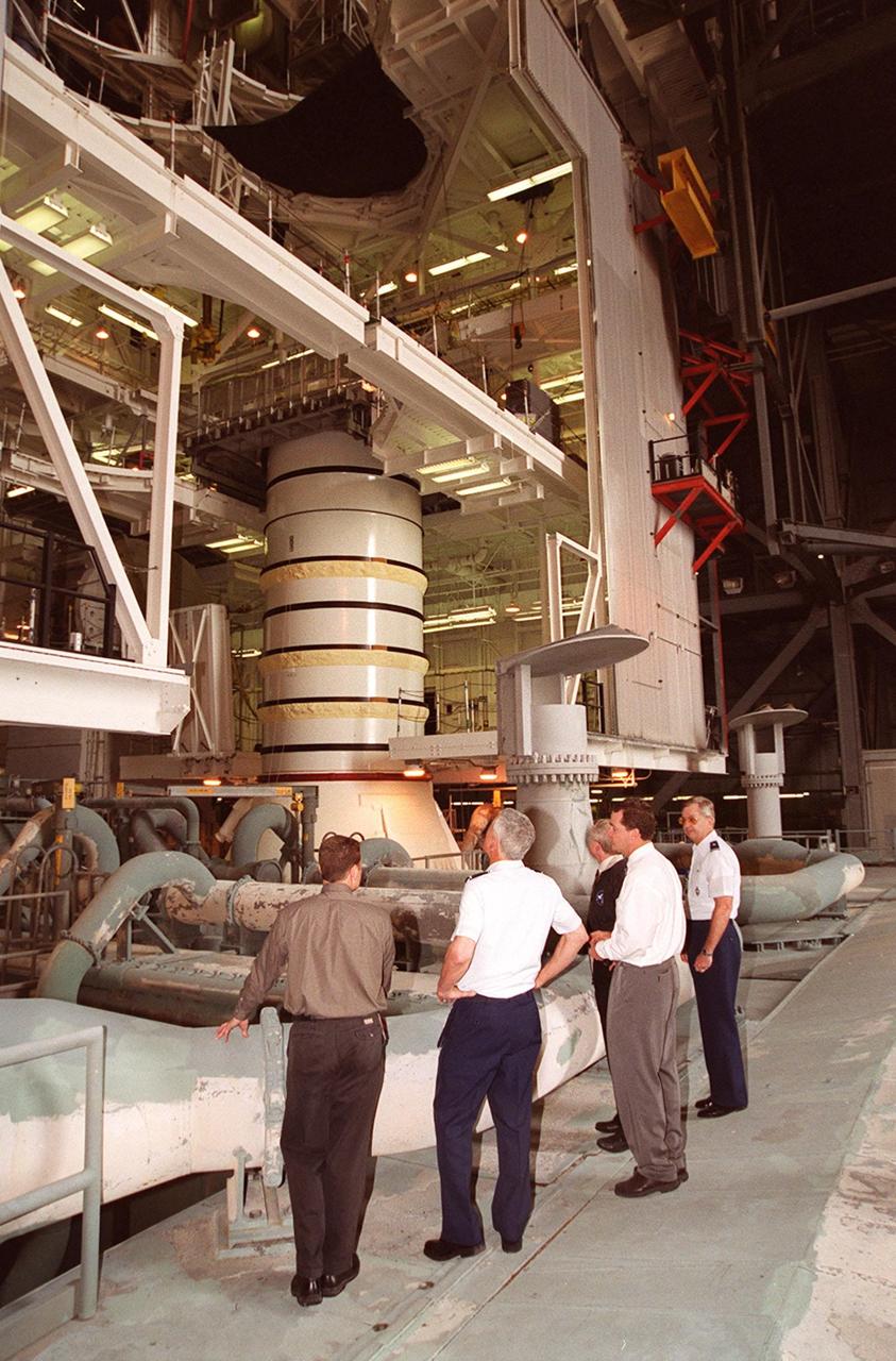 A distinguished group look at the solid rocket booster in the Vehicle Assembly Building. Starting second from left are Gen. Ralph Everhart, Commander, Space Command; Center Director Roy Bridges, Dave King, director of Shuttle Processing, and Brig. Gen. Donald Pettit, Commander of the 45th Space Wing, Cape Canaveral