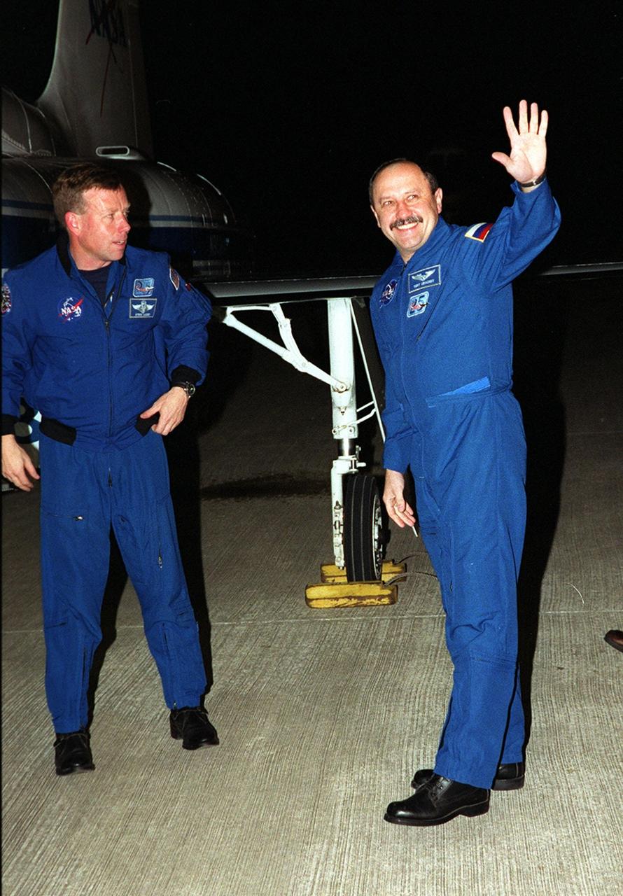 After landing at KSC’s Shuttle Landing Facility, Russian cosmonaut and STS-102 Mission Specialist Yury Usachev (right) waves to the media. Pilot James Kelly (left) is ready to join the other crew members at the microphone. The crew comprises Commander James Wetherbee, Kelly, and Mission Specialists Andrew Thomas, Paul Richards, James Voss, Susan Helms and Usachev. Helms, Usachev and Voss are also the Expedition Two crew replacing Expedition One on the International Space Station. STS-102 will be carrying the Multi-Purpose Logistics Module Leonardo, the primary delivery system used to resupply and return Station cargo requiring a pressurized environment. Leonardo will deliver up to 10 tons of laboratory racks filled with equipment, experiments and supplies for outfitting the newly installed U.S. Laboratory Destiny. STS-102 is scheduled to launch March 8 at 6:42 a.m. EST
