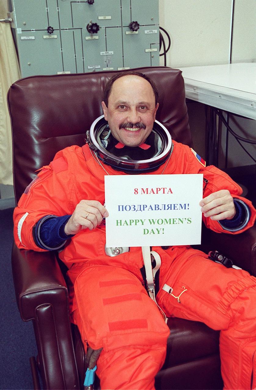 STS-102 Mission Specialist Yury Usachev, a Russian cosmonaut, shows his support of International Women’s Day, March 8, with a sign in both Cyrillic and English. This will be Usachev’s second Shuttle flight. Usachev is also part of a crew, known as Expedition One, who will be replacing Expedition One on the International Space Station. STS-102 is the eighth construction flight to the Space Station, carrying the Multi-Purpose Logistics Module Leonardo. The primary delivery system used to resupply and return Station cargo requiring a pressurized environment, Leonardo will deliver up to 10 tons of laboratory racks filled with equipment, experiments and supplies for outfitting the newly installed U.S. Laboratory Destiny. Discovery is set to launch March 8 at 6:42 a.m. EST. The 12-day mission is expected to end with a landing at KSC on March 20
