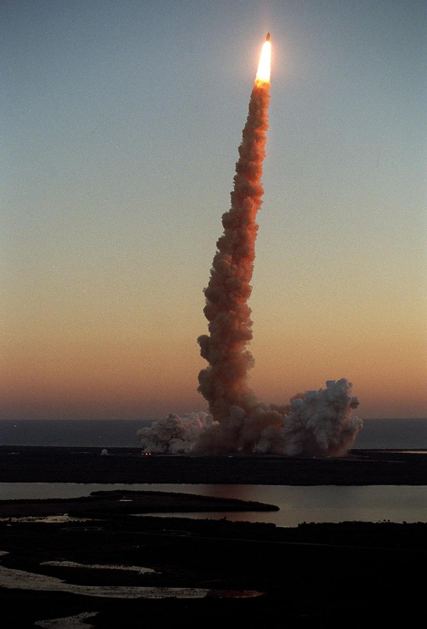 KENNEDY SPACE CENTER, Fla. -- Sunrise paints the exhaust trail of Space Shuttle Discovery a rosy hue at liftoff on mission STS-102 . Liftoff occurred at 6:42:09 EST for the eighth flight to the International Space Station