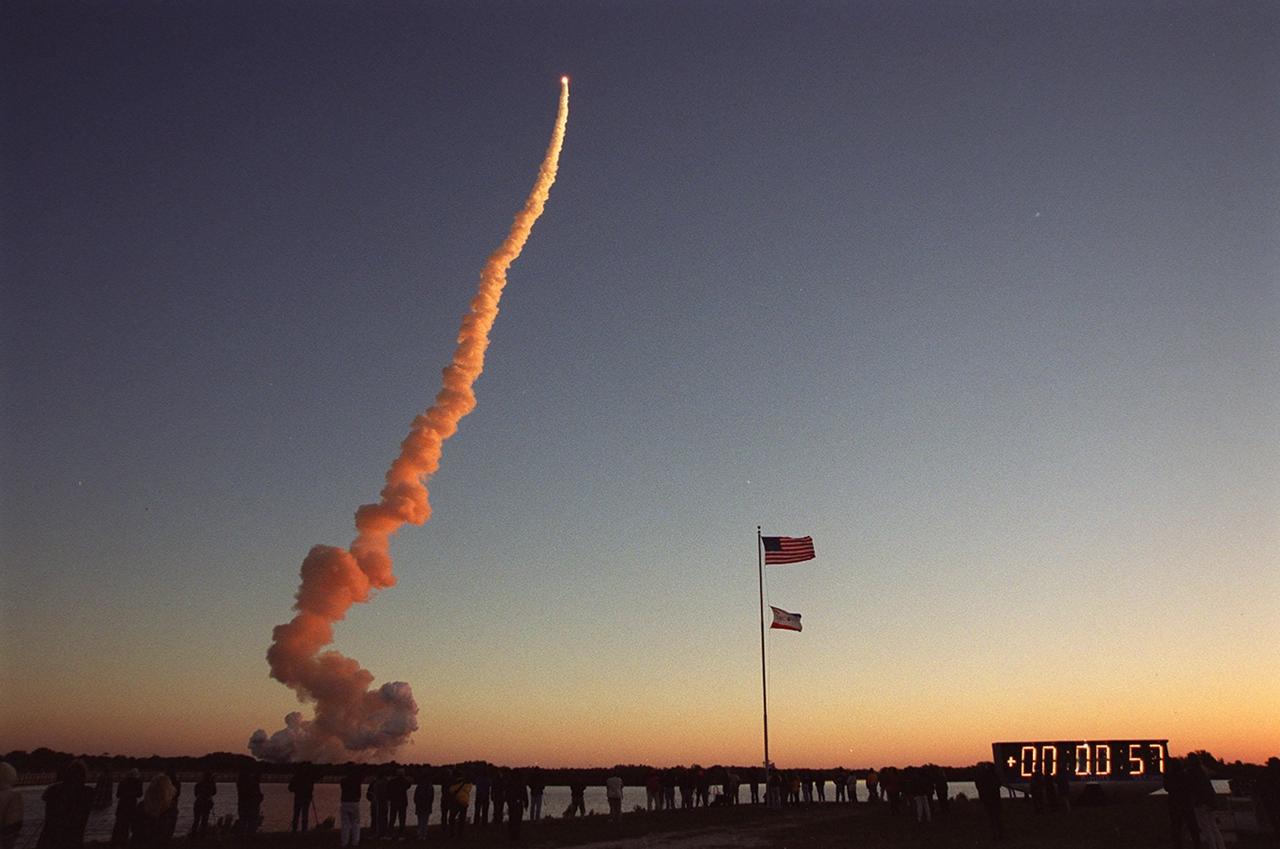 KENNEDY SPACE CENTER, Fla. -- Spectators line the banks of the turn basin to watch the dawn launch of Space Shuttle Discovery on mission STS-102. The rosy sky pales in comparison to the deep rose of the orbiter’s exhaust trail that captures the rising sun’s rays. Liftoff occurred at 6:42:09 EST for the eighth flight to the International Space Station