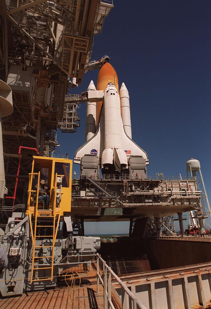 KENNEDY SPACE CENTER, Fla. -- With the Rotating Service Structure rolled back, Space Shuttle Discovery is revealed, poised for launch on mission STS-102 at 6:42 a.m. EST March 8. It sits on the Mobile Launcher Platform, which straddles the flame trench below that helps deflect the intense heat of launch. Made of concrete and refractory brick, the trench is 490 feet long, 58 feet wide and 40 feet high. Situated above the external tank is the Gaseous Oxygen Vent Arm with the “beanie cap,” a vent hood. On this eighth construction flight to the International Space Station, Discovery carries the Multi-Purpose Logistics Module Leonardo, the primary delivery system used to resupply and return Station cargo requiring a pressurized environment. Leonardo will deliver up to 10 tons of laboratory racks filled with equipment, experiments and supplies for outfitting the newly installed U.S. Laboratory Destiny
