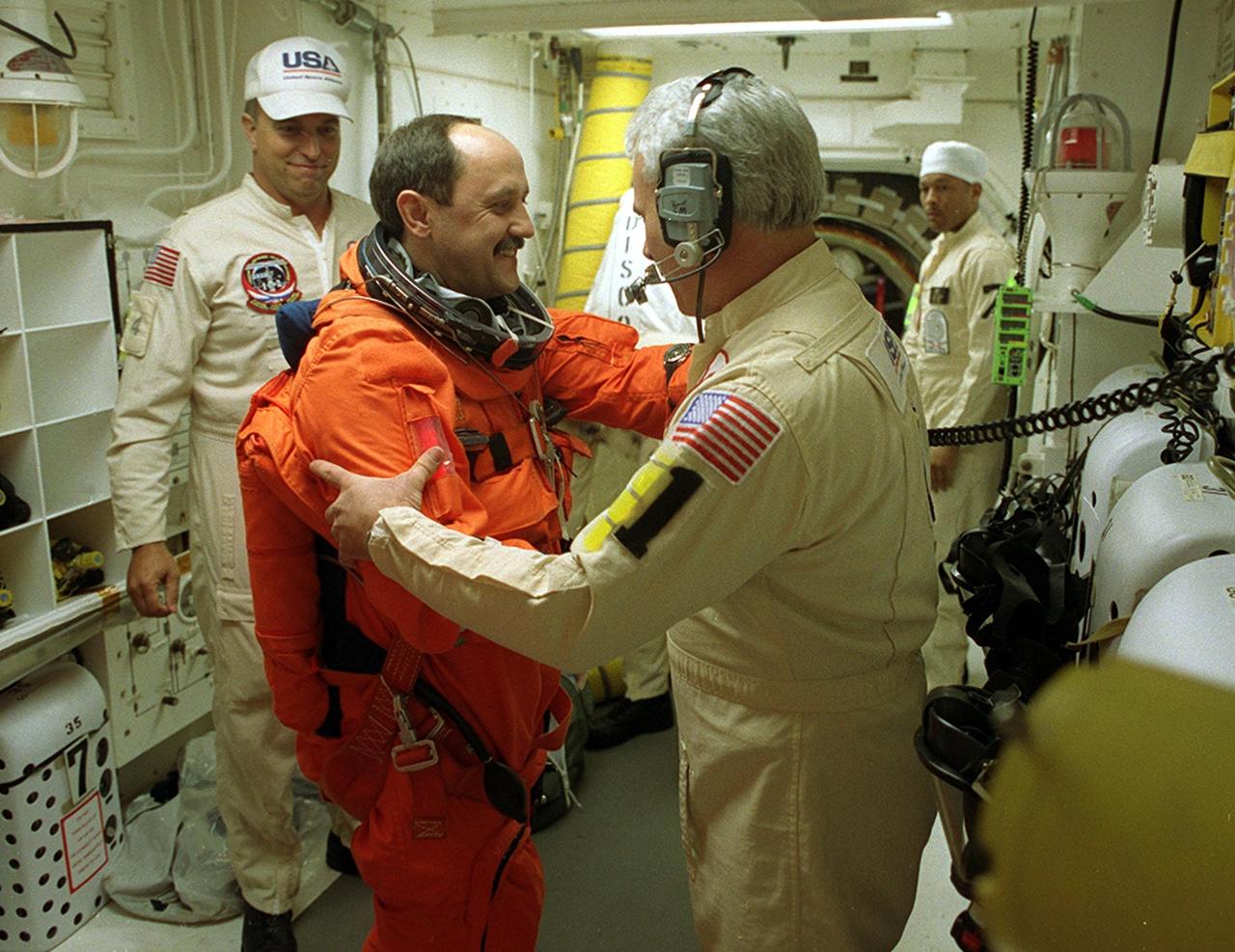 In the White Room, Launch Pad 39B, STS-102 Mission Specialist Yury Usachev gets warm greetings from one of the suit technicians helping with final preparations before entering Space Shuttle Discovery. STS-102 is Russian cosmonaut Usachev’s second Shuttle flight. He is also part of the Expedition Two crew flying on the mission to replace the Expedition One crew on the Station. Discovery is carrying the Multi-Purpose Logistics Module Leonardo on the eighth construction flight to the International Space Station. The primary delivery system used to resupply and return Station cargo requiring a pressurized environment, Leonardo will deliver up to 10 tons of laboratory racks filled with equipment, experiments and supplies for outfitting the newly installed U.S. Laboratory Destiny. Discovery is set to launch March 8 at 6:42 a.m. EST. The 12-day mission is expected to end with a landing at KSC on March 20