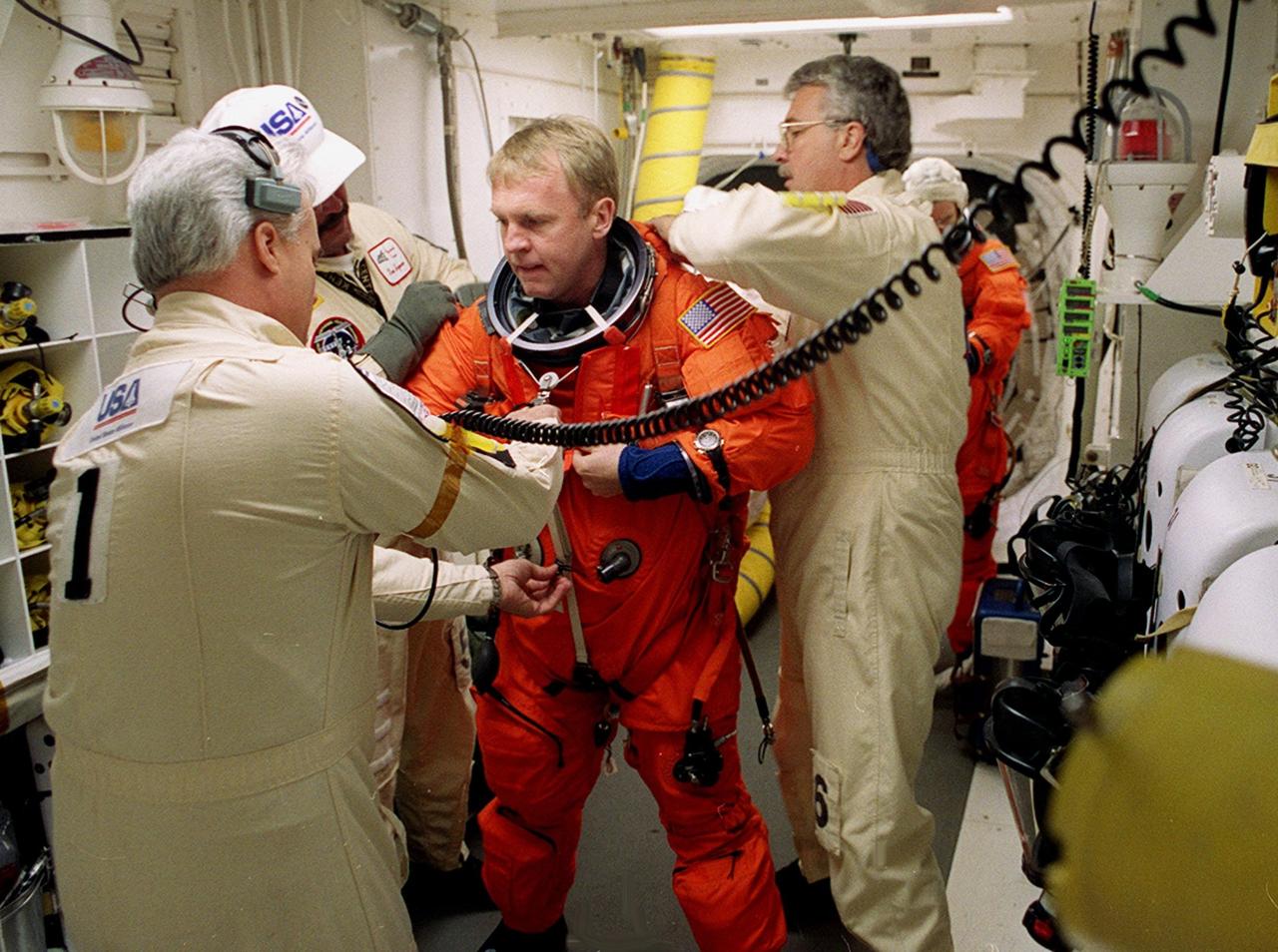 Before entering Space Shuttle Discovery, STS-102 Mission Specialist Andrew Thomas is helped with his launch and entry suit by technicians in the White Room. The mission is Thomas’s third Shuttle flight. Discovery is carrying the Multi-Purpose Logistics Module Leonardo on the eighth construction flight to the International Space Station. The primary delivery system used to resupply and return Station cargo requiring a pressurized environment, Leonardo will deliver up to 10 tons of laboratory racks filled with equipment, experiments and supplies for outfitting the newly installed U.S. Laboratory Destiny. Discovery is set to launch March 8 at 6:42 a.m. EST. The 12-day mission is expected to end with a landing at KSC on March 20