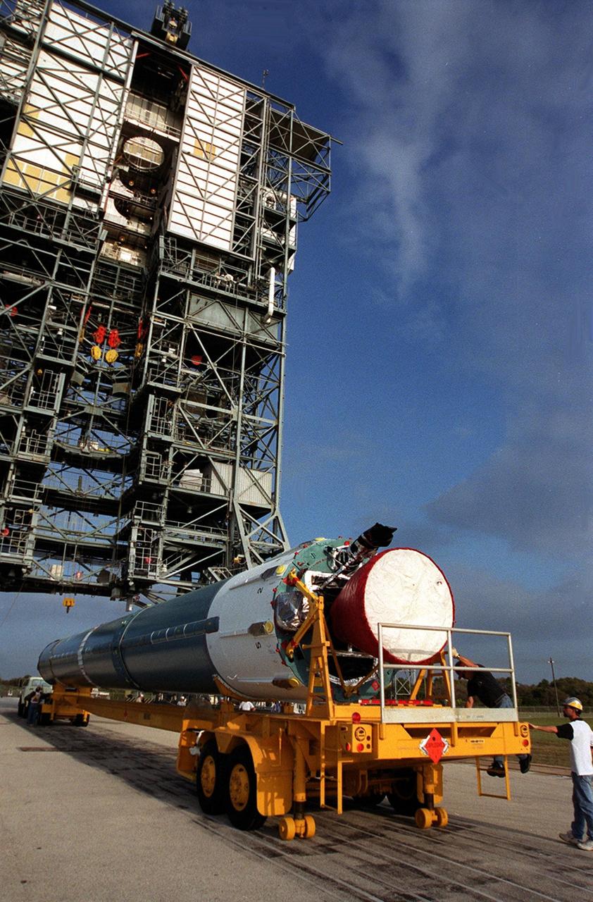 The first stage of a Boeing Delta rocket arrives on Launch Pad 17-A, Cape Canaveral Air Force Station. The rocket will carry the 2001 Mars Odyssey Orbiter, scheduled for launch April 7, 2001. Mars Odyssey contains three science instruments: THEMIS, the Gamma Ray Spectrometer (GRS), and the Mars Radiation Environment Experiment (MARIE). THEMIS will map the mineralogy and morphology of the Martian surface using a high-resolution camera and a thermal infrared imaging spectrometer. The GRS will achieve global mapping of the elemental composition of the surface and determine the abundance of hydrogen in the shallow subsurface. The MARIE will characterize aspects of the near-space radiation environment with regards to the radiation-related risk to human explorers