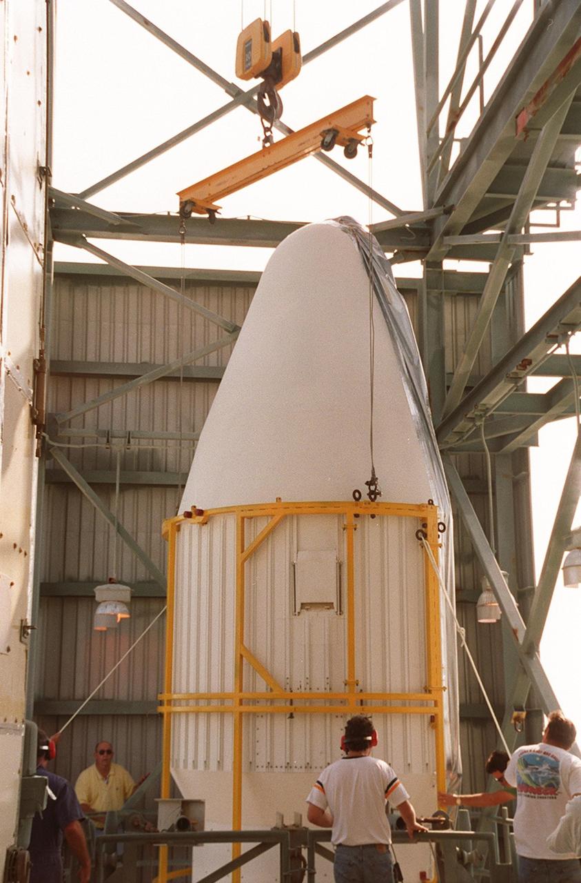Part of the fairing that will cover the Mars Odyssey Orbiter during launch reaches the top of the gantry at Launch Pad 17-A, Cape Canaveral Air Force Station. The 2001 Mars Odyssey Orbiter is scheduled for launch on a Delta rocket April 7, 2001. Mars Odyssey contains three science instruments: THEMIS, the Gamma Ray Spectrometer (GRS), and the Mars Radiation Environment Experiment (MARIE). THEMIS will map the mineralogy and morphology of the Martian surface using a high-resolution camera and a thermal infrared imaging spectrometer. The GRS will achieve global mapping of the elemental composition of the surface and determine the abundance of hydrogen in the shallow subsurface. The MARIE will characterize aspects of the near-space radiation environment with regards to the radiation-related risk to human explorers
