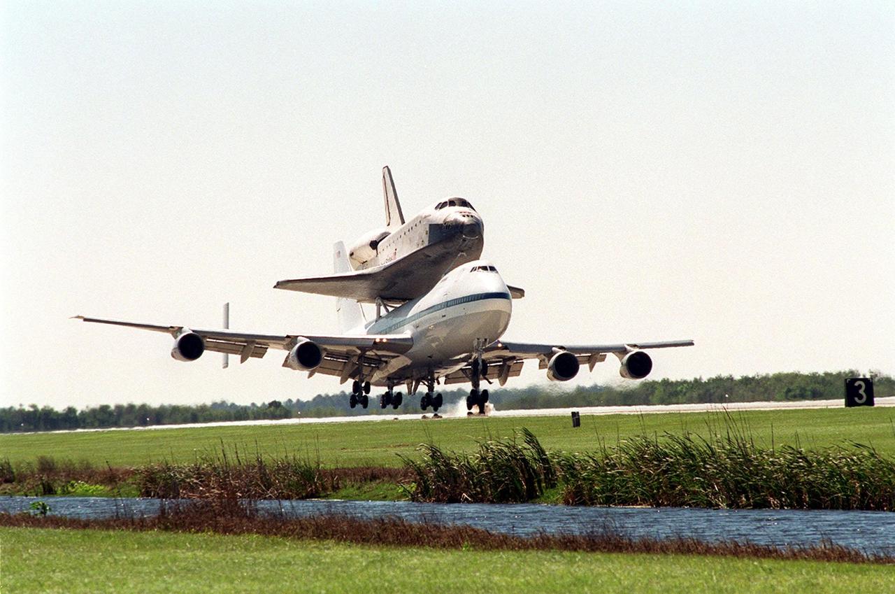 The Shuttle Carrier Aircraft, a modified Boeing 747, kicks up dust as it lands at KSC’s Shuttle Landing Facility with the orbiter Atlantis on top. Atlantis landed in California Feb. 19 concluding mission STS-98. The ferry flight began in California March 1; unfavorable weather conditions kept it on the ground at Altus AFB, Okla., until it could return to Florida. The orbiter will next fly on mission STS-104, the 10th construction flight to the International Space Station, scheduled June 8
