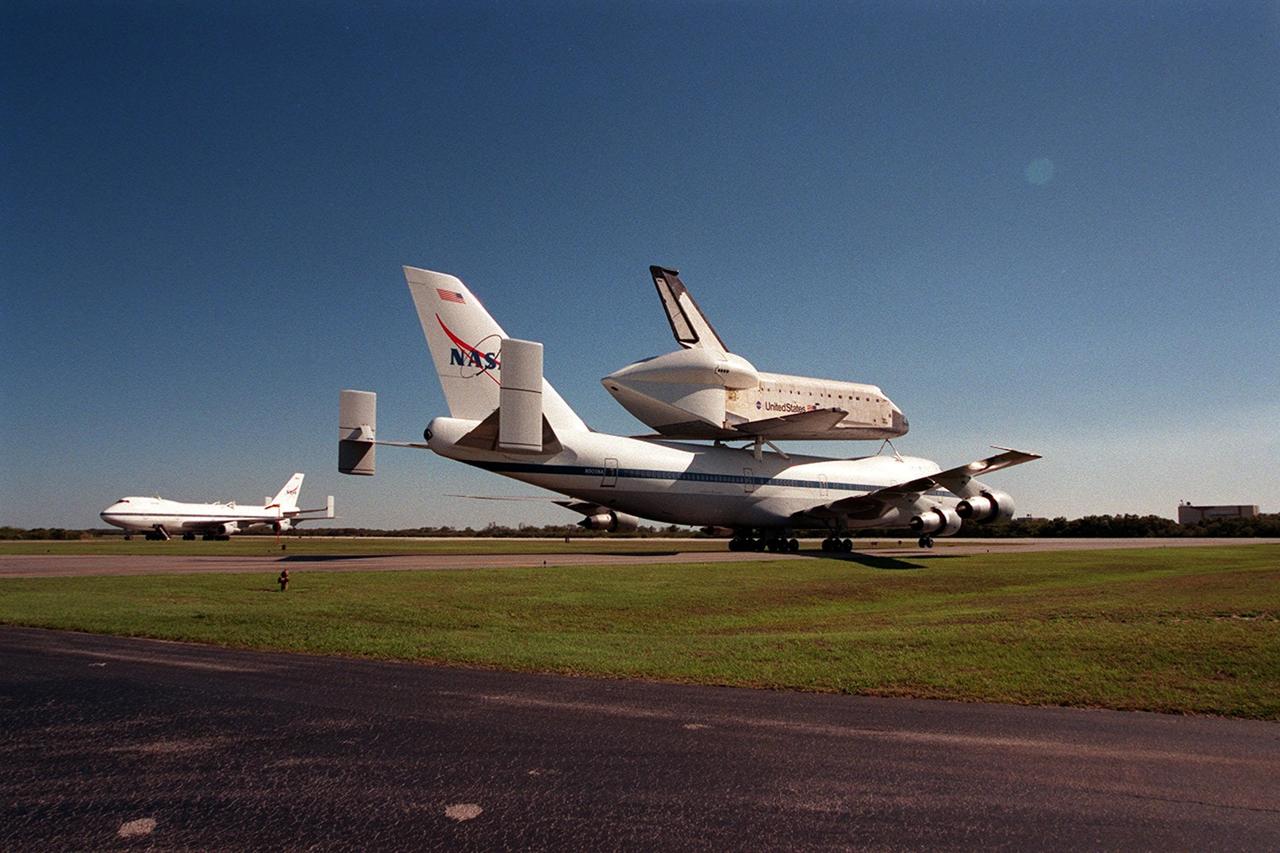 The Shuttle Carrier Aircraft with orbiter Columbia on top taxis at the Cape Canaveral Air Force Station Skid Strip. In the background is another SCA, which brought Atlantis back to KSC from California. The ferry flight began in California March 1. Unfavorable weather conditions kept it on the ground at Dyess AFB, Texas, until it could return to Florida. Columbia is returning from a 17-month-long modification and refurbishment process as part of a routine maintenance plan. The orbiter will next fly on mission STS-107, scheduled Oct. 25