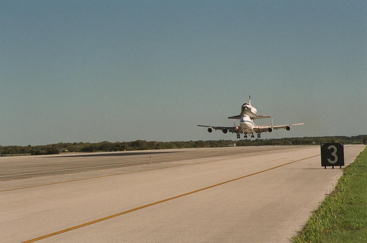 The Shuttle Carrier Aircraft with orbiter Columbia on top prepares to land at the KSC Shuttle Landing Facility after leaving the Cape Canaveral Air Force Station Skid Strip. The ferry flight began in California March 1. Unfavorable weather conditions kept it on the ground at Dyess AFB, Texas, until it could return to Florida. It landed temporarily at the CCAFS Skid Strip until Atlantis, which had already landed at the SLF, could be transferred. Columbia is returning from a 17-month-long modification and refurbishment process as part of a routine maintenance plan. The orbiter will next fly on mission STS-107, scheduled Oct. 25