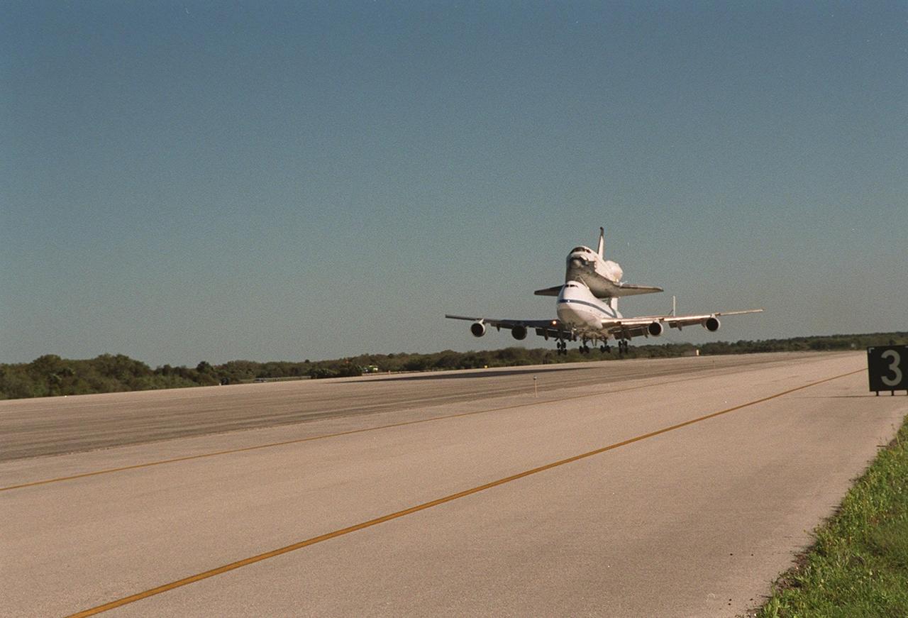 The Shuttle Carrier Aircraft with orbiter Columbia on top is close to touchdown at the KSC Shuttle Landing Facility after leaving the Cape Canaveral Air Force Station Skid Strip. The ferry flight began in California March 1. Unfavorable weather conditions kept it on the ground at Dyess AFB, Texas, until it could return to Florida. It landed temporarily at the CCAFS Skid Strip until Atlantis, which had already landed at the SLF, could be transferred. Columbia is returning from a 17-month-long modification and refurbishment process as part of a routine maintenance plan. The orbiter will next fly on mission STS-107, scheduled Oct. 25