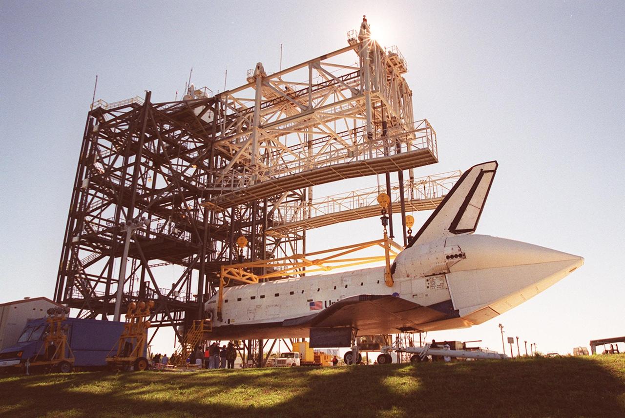 At the mate/demate device at KSC’s Shuttle Landing Facility, Atlantis is lowered onto its wheels in preparation for being towed to the Orbiter Processing Facility. This view of Atlantis shows the tail cone that orbiters use when being carried piggyback on ferry flights atop a Shuttle Carrier Aircraft. The tail cone protects the aft engine area and provides a more efficient aeronautical dimension during flight. Atlantis returned from California atop the SCA after its Feb. 19 landing at Edwards Air Force Base concluding mission STS-98. The ferry flight began March 1; unfavorable weather conditions kept it on the ground at Altus AFB, Okla., until it could return to Florida. In the Orbiter Processing Facility, Atlantis will be prepared for mission STS-104, the 10th construction flight to the International Space Station, scheduled to launch June 8
