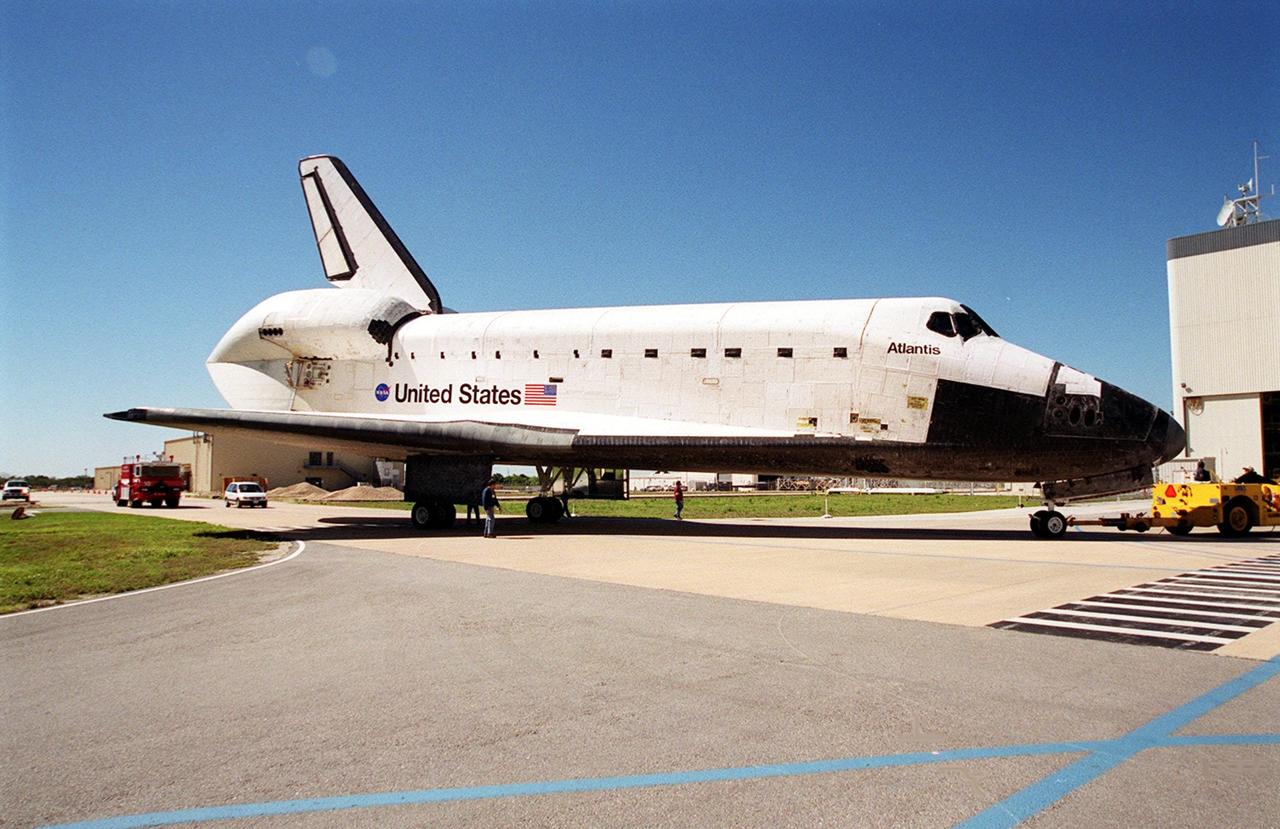 KENNEDY SPACE CENTER, FLA. -- On its journey to the Orbiter Processing Facility, Atlantis, in tow, turns from the tow-way toward the OPF. Atlantis returned from California atop a Shuttle Carrier Aircraft after its Feb. 19 landing at Edwards Air Force Base, concluding mission STS-98. The ferry flight began March 1; unfavorable weather conditions kept it on the ground at Altus AFB, Okla., until it could return to Florida. In the Orbiter Processing Facility, Atlantis will be prepared for mission STS-104, the 10th construction flight to the International Space Station, scheduled to launch June 8