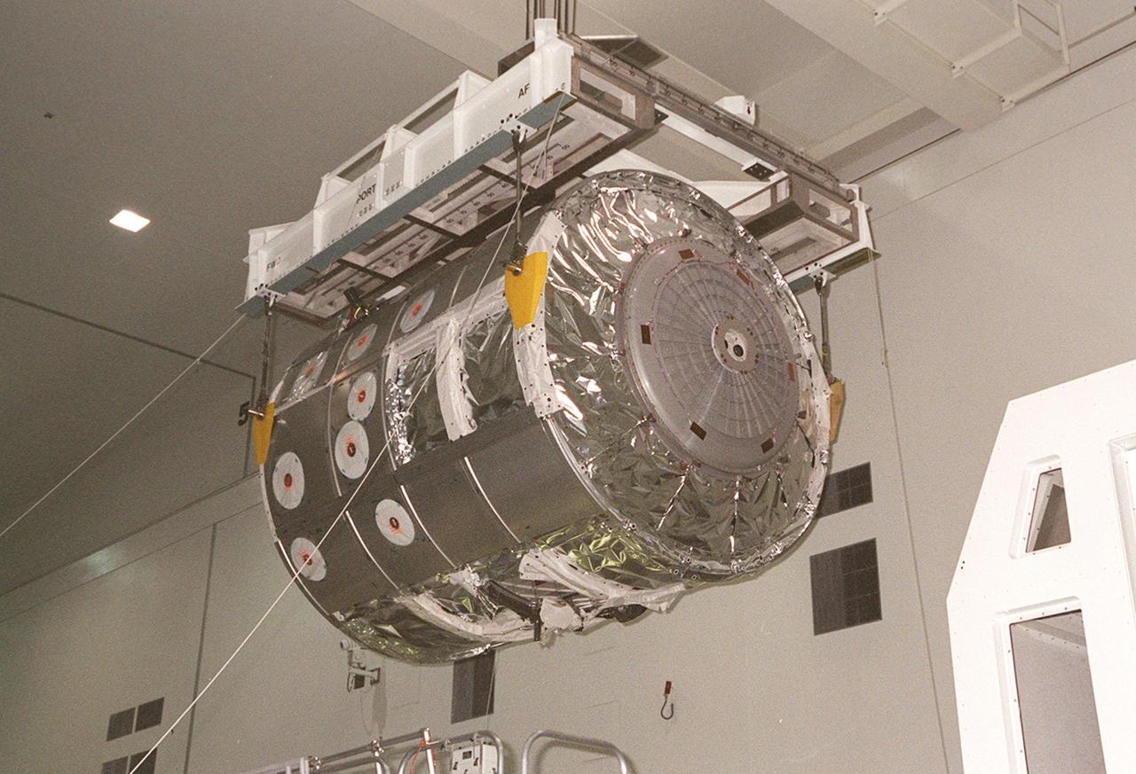 KENNEDY SPACE CENTER, FLA. -- In the Space Station Processing Facility, an overhead crane lifts the Multi-Purpose Logistics Module Raffaello off its workstand to move it to to a scale for weight and balance. Raffaello is the second MPLM built by the Italian Space Agency, and serves as a reusable logistics carrier and primary delivery system used to resupply and return station cargo requiring a pressurized environment. Weighing nearly 4.5 tons, the Raffaello measures 21 feet long and 15 feet in diameter. The MPLM will fly on mission STS-100, scheduled to launch aboard Space Shuttle Endeavour on April 19