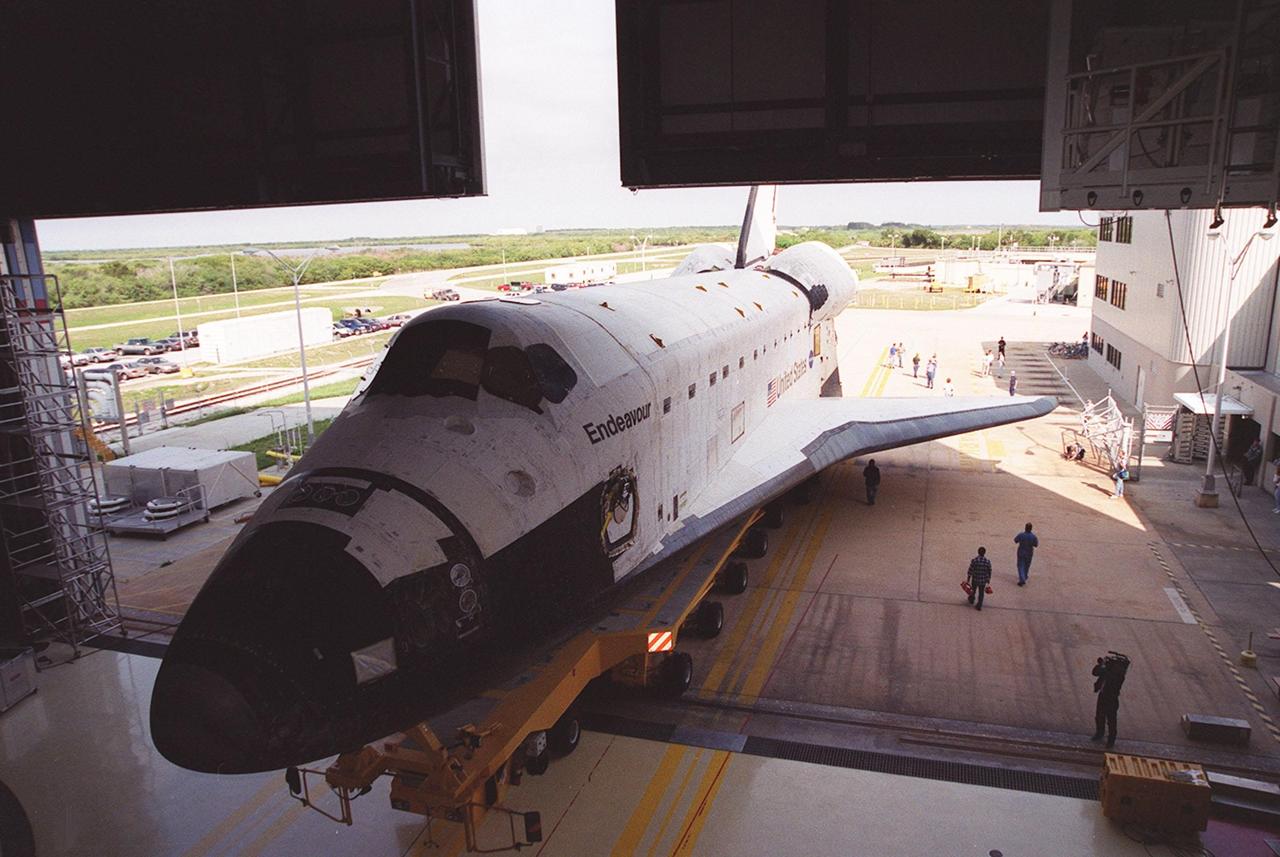 KENNEDY SPACE CENTER, FLA. -- Endeavour backs out of Orbiter Processing Facility bay 2 atop an orbiter transporter for rollover to the Vehicle Assembly Building. In the VAB, Endeavour will be stacked with its solid rocket boosters and external tank atop the Mobile Launcher Platform in high bay 3. Endeavour is scheduled to launch April 19 on mission STS-100, the ninth flight to the International Space Station