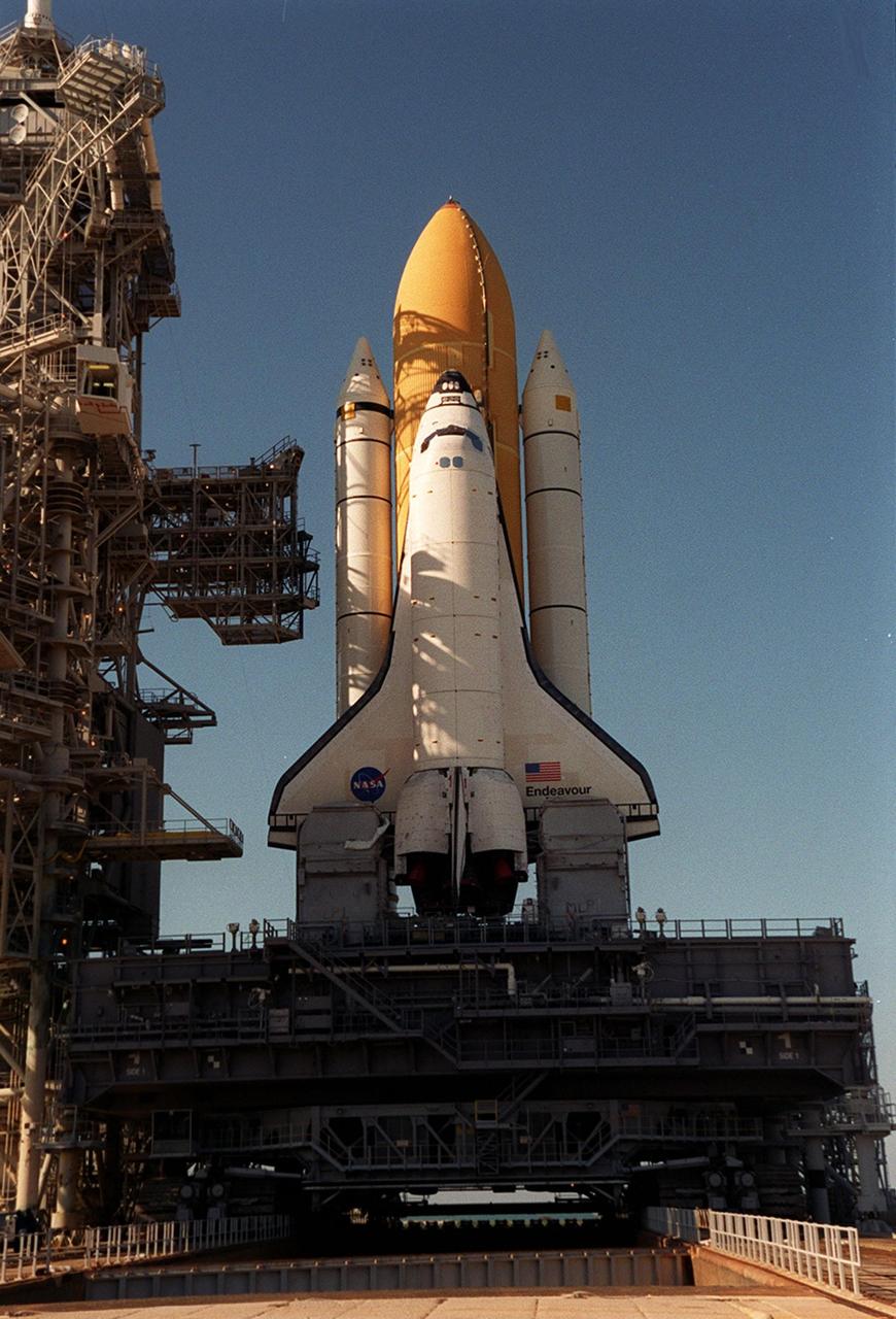 KENNEDY SPACE CENTER, FLA. -- The afternoon sun streaming through the Fixed Service Structure throws grid-like shadows over Space Shuttle Endeavour after arriving on Launch Pad 39A. In the background is seen the deep blue of the Atlantic Ocean. Endeavour is expected to lift off on mission STS-100 on April 19, carrying the Multi-Purpose Logistics Module Raffaello and the Canadian robotic arm, SSRMS, to the International Space Station