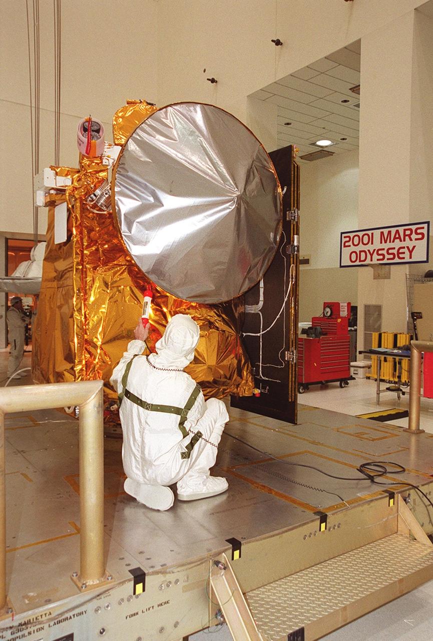 A worker in the Space Assembly and Encapsulation Facility 2 checks out the Mars Odyssey Orbiter before its move to the third stage of a Delta rocket. The Mars Odyssey is scheduled for launch on April 7, 2001, aboard a Delta II rocket from Launch Pad 17-A, Cape Canaveral Air Force Station