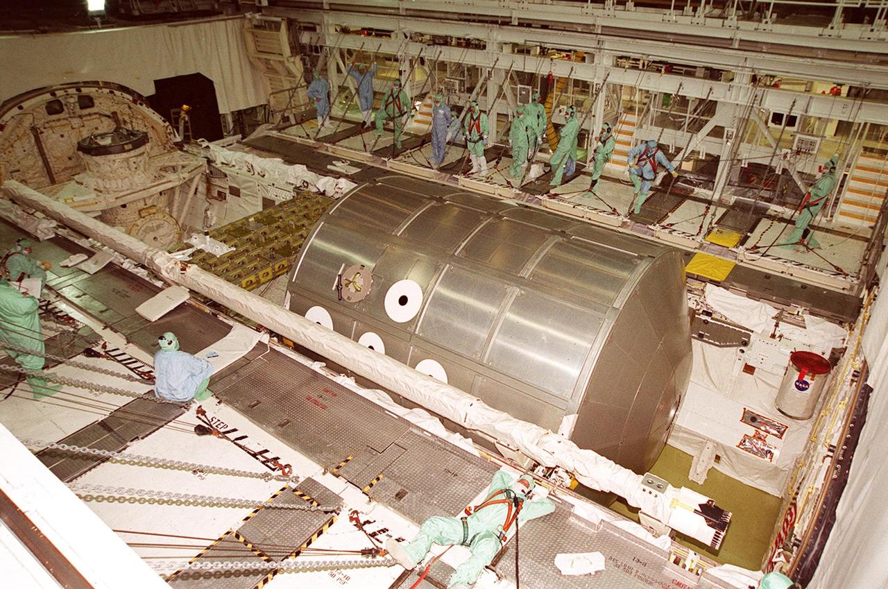 KENNEDY SPACE CENTER, FLA. -- In the Orbiter Processing Facility bay 2, Discovery’s payload bay doors are open to reveal the Multi-Purpose Logistics Module Leonardo, which has just returned from its first round trip to the International Space Station on mission STS-102. Behind it to the left is the integrated cargo carrier. Attached to the length of the payload bay, in front of Leonardo, is the robotic arm that was used to remove and position Leonardo on the ISS. Leonardo will be lifted from the payload bay and transferred to the SSPF to prepare it for future missions. The MPLM serves as a cargo van, carrying equipment and supplies to the Space Station