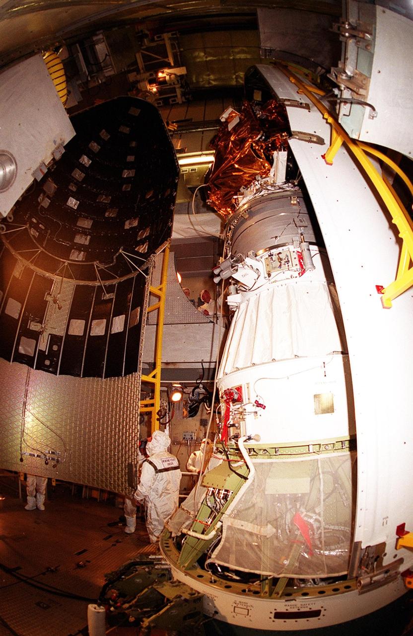 At Launch Complex 17-A, Cape Canaveral Air Force Station, workers move another piece of the Delta rocket fairing that will enclose the Mars Odyssey spacecraft. NASA’s latest explorer carries three scientific instruments to map the chemical and mineralogical makeup of Mars: a thermal-emission imaging system, a gamma ray spectrometer and a Martian radiation environment experiment. The imaging system will map the planet with high-resolution thermal images and give scientists an increased level of detail to help them understand how the mineralogy of the planet relates to the land forms. In addition, Odyssey will serve as a communications relay for U.S. and international landers arriving at Mars in 2003/2004. The Mars Odyssey is scheduled for launch aboard a Delta II rocket April 7, 2001, at 11:02 a.m. EST