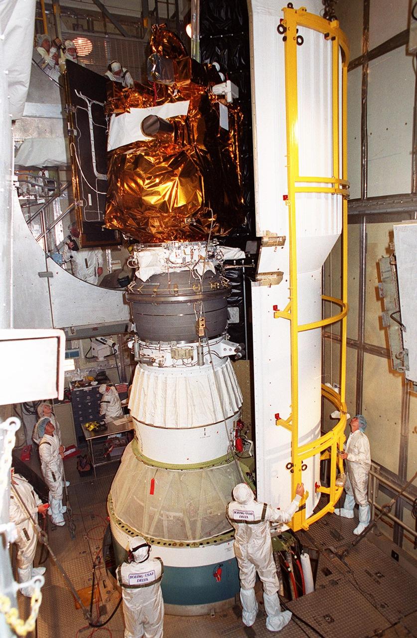 Workers at Launch Complex 17-A, Cape Canaveral Air Force Station, carefully maneuver the Delta rocket fairing as it closes in on the Mars Odyssey spacecraft. NASA’s latest explorer carries three scientific instruments to map the chemical and mineralogical makeup of Mars: a thermal-emission imaging system, a gamma ray spectrometer and a Martian radiation environment experiment. The imaging system will map the planet with high-resolution thermal images and give scientists an increased level of detail to help them understand how the mineralogy of the planet relates to the land forms. In addition, Odyssey will serve as a communications relay for U.S. and international landers arriving at Mars in 2003/2004. The Mars Odyssey is scheduled for launch aboard a Delta II rocket April 7, 2001, at 11:02 a.m. EST