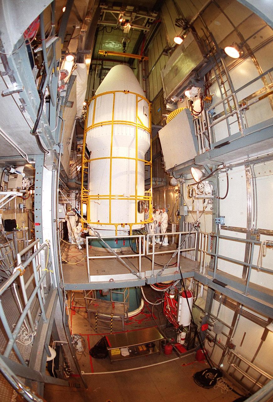 At Launch Complex 17-A, Cape Canaveral Air Force Station, the pristine white fairing comes together, enclosing the Mars Odyssey spacecraft inside. The Mars Odyssey is scheduled for launch aboard a Delta II rocket April 7, 2001, at 11:02 a.m. EST. NASA’s latest explorer carries three scientific instruments to map the chemical and mineralogical makeup of Mars: a thermal-emission imaging system, a gamma ray spectrometer and a Martian radiation environment experiment. The imaging system will map the planet with high-resolution thermal images and give scientists an increased level of detail to help them understand how the mineralogy of the planet relates to the land forms. In addition, Odyssey will serve as a communications relay for U.S. and international landers arriving at Mars in 2003/2004