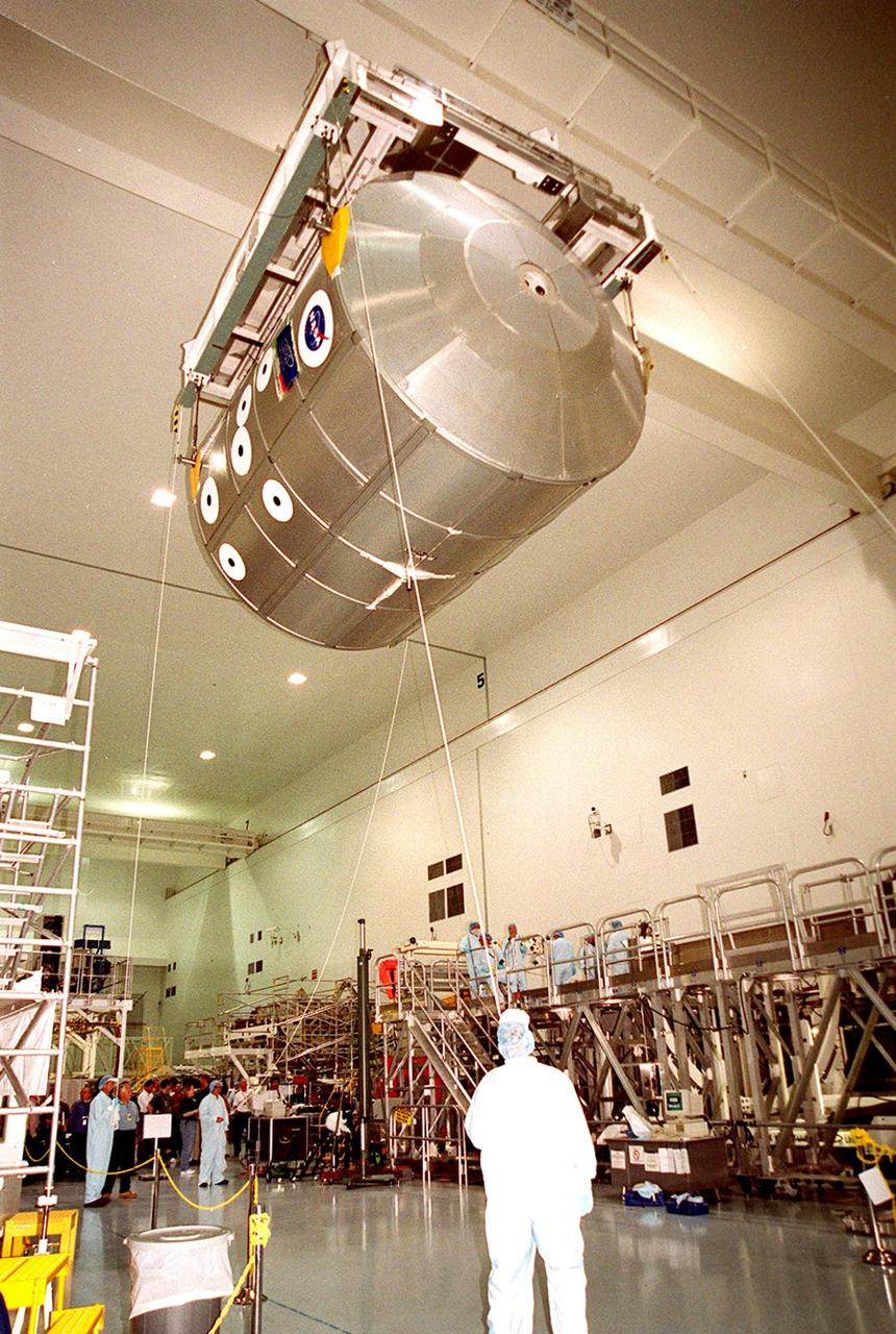 KENNEDY SPACE CENTER, FLA. -- Suspended from an overhead crane in the Space Station Processing Facility, the Multi-Purpose Logistics Module Leonardo glides toward the workstand at right. The MPLM joins two others, Raffaello and Donatello, in the SSPF being prepared for future launches to the International Space Station. The three MPLMs are being used as cargo vans to carry supplies, equipment and research racks to the Space Station and back to KSC. Leonardo recently returned from its maiden voyage to the Station on mission STS-102