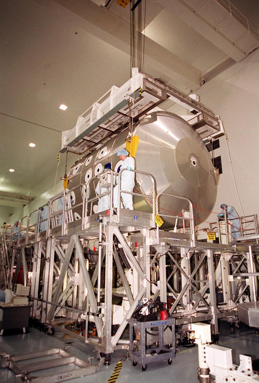 KENNEDY SPACE CENTER, FLA. -- In the Space Station Processing Facility, the Multi-Purpose Logistics Module Leonardo is lowered onto a workstand. The MPLM joins two others, Raffaello and Donatello, in the SSPF being prepared for future launches to the International Space Station. The three MPLMs are being used as cargo vans to carry supplies, equipment and research racks to the Space Station and back to KSC. Leonardo recently returned from its maiden voyage to the Station on mission STS-102