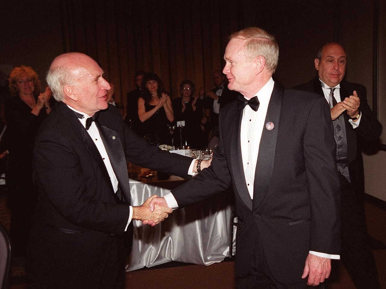 Center Director Roy Bridges (center) is congratulated by Spaceport Florida Authority Executive Director Ed Gormel (left) at the 12th annual Dr. Kurt H. Debus Award Dinner held at the KSC Visitor Complex’s Debus Conference Facility. At right is Rick Abramson, president of Delaware North Parks Services of Spaceport, Inc. Bridges was presented with the 2001 Dr. Kurt H. Debus Award honoring his progressive, visionary leadership and contributions to space technology and exploration. The Florida Committee of the National Space Club presented the award. The Debus Award was first given in 1980. Created to recognize significant achievements and contributions made in Florida to the American aerospace effort, the award is named for the KSC’s first Director, Dr. Kurt H. Debus