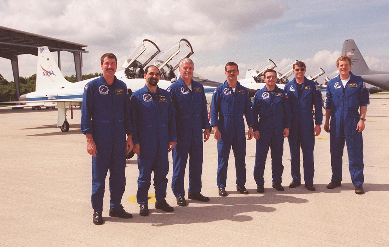  The STS-100 crew poses for a photo after their arrival at KSC to complete Terminal Countdown Demonstration Test activities that were postponed earlier. Standing, from left, are Commander Kent V. Rominger; Mission Specialists Umberto Guidoni, John L. Phillips, Chris A. Hadfield and Yuri V. Lonchakov; Pilot Jeffrey S. Ashby; and Mission Specialist Scott E. Parazynski. An international crew, Guidoni is with the European Space Agency, Hadfield the Canadian Space Agency, and Lonchakov the Russian Space and Aviation Agency. The TCDT includes emergency escape training, payload bay walkdown, and a simulated launch countdown. The primary payload comprises the Canadian robotic arm, SSRMS, and Multi-Purpose Logistics Module, Raffaello. Launch of Space Shuttle Endeavour on mission STS-100 is targeted for April 19 at 2:41 p.m. EDT from Launch Pad 39A
