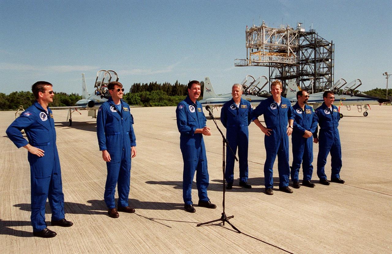 The STS-100 crew speak to the media after their arrival at the KSC Shuttle Landing Facility. Standing, from left, are Mission Specialist Chris A. Hadfield, Pilot Jeffrey S. Ashby, Commander Kent V. Rominger at the microphone, and Mission Specialists John L. Phillips, Scott E. Parazynski, Umberto Guidoni and Yuri V. Lonchakov. The international crew represents, along with America, the Canadian Space Agency (Hadfield) , the European Space Agency (Guidoni), and the Russian Aviation and Space Agency (Lonchakov). The 11-day mission to the International Space Station will deliver and integrate the Spacelab Logistics Pallet/Launch Deployment Assembly, which includes the Space Station Remote Manipulator system and the UHF Antenna, and the Multi-Purpose Logistics Module Raffaello. Liftoff on mission STS-100 is scheduled at 2:41 p.m. EDT April 19