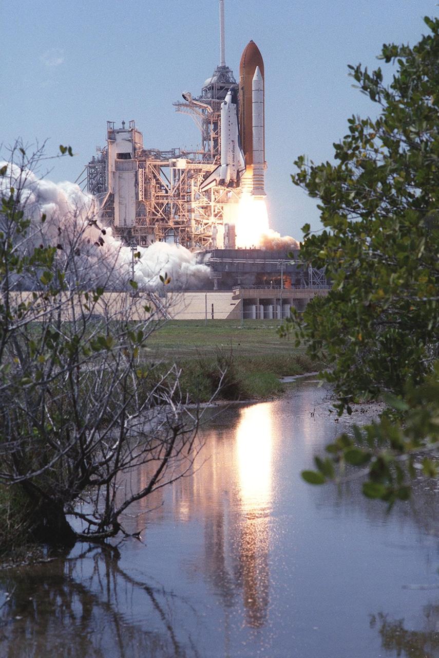 KENNEDY SPACE CENTER, FLA. -- The brilliant exhaust of Space Shuttle Endeavour as it lifts off Launch Pad 39A reflects in the nearby water. Liftoff of STS-100 on the ninth flight to the International Space Station occurred at 2:40:42 p.m. EDT. The 11-day mission will deliver and integrate the Spacelab Logistics Pallet/Launch Deployment Assembly, which includes the Space Station Remote Manipulator System and the UHF Antenna. The mission includes two planned spacewalks for installation of the SSRMS on the Station. Also onboard is the Multi-Purpose Logistics Module Raffaello, carrying resupply stowage racks and resupply/return stowage platforms