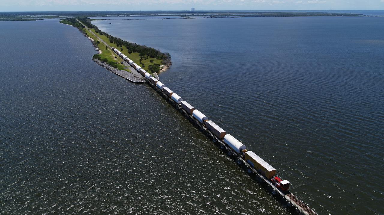 Twin rocket boosters for NASA’s Space Launch System (SLS) that will power Artemis missions to the Moon have arrived at the agency’s Kennedy Space Center in Florida. The two motor segments, each comprised of five segments, arrived at Kennedy’s Rotation, Processing and Surge Facility (RPSF) on June 15, 2020, by train from a Northrop Grumman manufacturing facility in Promontory, Utah. The booster segments will remain in the RPSF for inspection prior to processing until it’s time to move them to the Vehicle Assembly Building for stacking on the mobile launcher. This is the first piece of flight hardware to arrive at Kennedy by train for the Artemis program, but NASA’s Exploration Ground Systems (EGS) can expect to receive additional hardware soon, including the Launch Vehicle Service Adapter and the rocket’s core stage. NASA is working toward an Artemis I launch date in 2021, keeping the program moving at the best possible pace toward the earliest possible opportunity. 