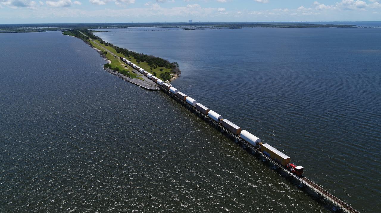 Twin rocket boosters for NASA’s Space Launch System (SLS) that will power Artemis missions to the Moon have arrived at the agency’s Kennedy Space Center in Florida. The two motor segments, each comprised of five segments, arrived at Kennedy’s Rotation, Processing and Surge Facility (RPSF) on June 15, 2020, by train from a Northrop Grumman manufacturing facility in Promontory, Utah. The booster segments will remain in the RPSF for inspection prior to processing until it’s time to move them to the Vehicle Assembly Building for stacking on the mobile launcher. This is the first piece of flight hardware to arrive at Kennedy by train for the Artemis program, but NASA’s Exploration Ground Systems (EGS) can expect to receive additional hardware soon, including the Launch Vehicle Service Adapter and the rocket’s core stage. NASA is working toward an Artemis I launch date in 2021, keeping the program moving at the best possible pace toward the earliest possible opportunity. 