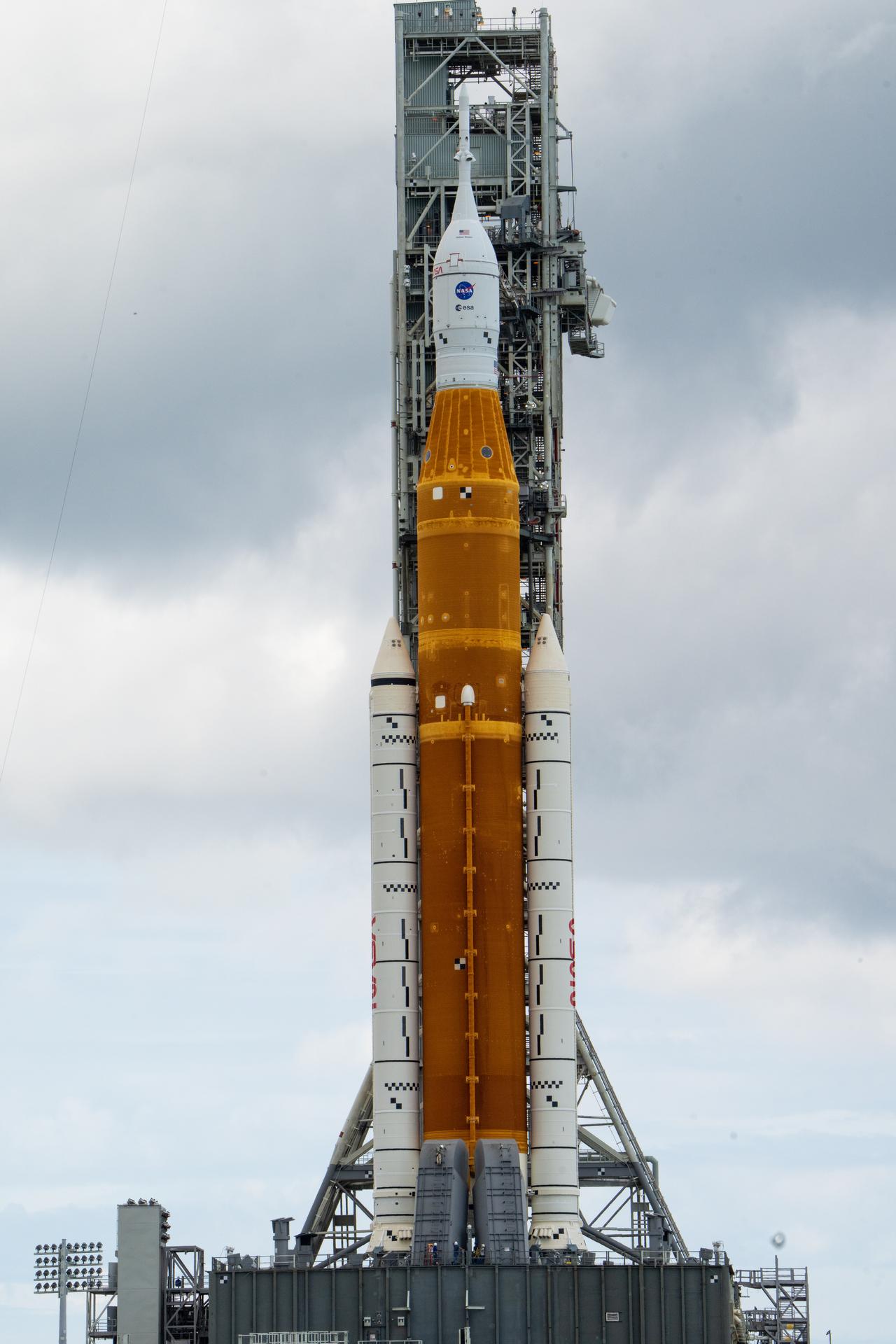 NASA’s Space Launch System (SLS) rocket with the Orion spacecraft aboard is seen atop the mobile launcher at Launch 39B at NASA’s Kennedy Space Center in Florida. Artemis I mission is the first integrated test of the agency’s deep space exploration systems: the Space Launch System rocket, Orion spacecraft, and supporting ground systems. The mission is the first in a series of increasingly complex missions to the Moon. Launch of the uncrewed flight test is targeted for no earlier than Aug. 29 at 8:33 a.m. ET. With Artemis missions, NASA will land the first woman and first person of color on the Moon, using innovative technologies to explore more of the lunar surface than ever before.