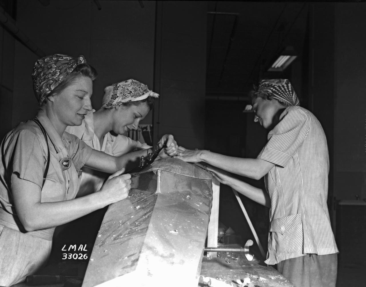 Women Adequately Filling Posts in NACA Laboratory: Nearly 200 women are employed at the Langley Laboratory of the National Advisory Committee for Aeronautics in a limited capacity as mechanics’ helpers and minor laboratory aids on the jobs formerly handled by men, according to E.H. Derring, of the Aerodynamics Division. Many phases of the operations of various wind tunnels at the laboratory are now handled by women with experienced male supervision. Mr. Derring said, pointing out that the reading of the data indicated on wind tunnel instruments during a test is done in a large measure by women.  In addition to reading the instruments and computing and integrating engineering test data obtained from tunnel investigations, the minor laboratory aides assist in the preparation of aircraft models preliminary to testing. Women employees who will serve in the Aerodynamics Division of the Laboratory attend an orientation class for two weeks, during which they receive instruction on phases of the work they will do and their aptitudes for different types of work are evaluated in order that they may be properly placed.  More than 100 women are employed in minor laboratory apprentices, performing mechanical work heretofore done by men. These women are employed in the various shops of the laboratory.  Women in the woodworking shops are taught to operate 15 different machines in carrying out their assignments. Norfolk new paper article from 1943 by Lee Dickinson.