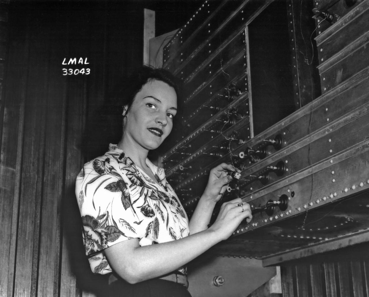 Women Adequately Filling Posts in NACA Laboratory: Nearly 200 women are employed at the Langley Laboratory of the National Advisory Committee for Aeronautics in a limited capacity as mechanics’ helpers and minor laboratory aids on the jobs formerly handled by men, according to E.H. Derring, of the Aerodynamics Division. Many phases of the operations of various wind tunnels at the laboratory are now handled by women with experienced male supervision. Mr. Derring said, pointing out that the reading of the data indicated on wind tunnel instruments during a test is done in a large measure by women.  In addition to reading the instruments and computing and integrating engineering test data obtained from tunnel investigations, the minor laboratory aides assist in the preparation of aircraft models preliminary to testing. Women employees who will serve in the Aerodynamics Division of the Laboratory attend an orientation class for two weeks, during which they receive instruction on phases of the work they will do and their aptitudes for different types of work are evaluated in order that they may be properly placed.  More than 100 women are employed in minor laboratory apprentices, performing mechanical work heretofore done by men. These women are employed in the various shops of the laboratory.  Women in the woodworking shops are taught to operate 15 different machines in carrying out their assignments. Norfolk new paper article from 1943 by Lee Dickinson.