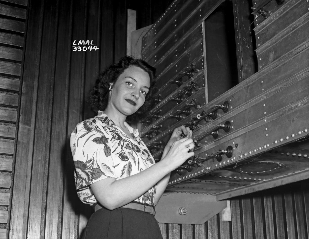Women Adequately Filling Posts in NACA Laboratory: Nearly 200 women are employed at the Langley Laboratory of the National Advisory Committee for Aeronautics in a limited capacity as mechanics’ helpers and minor laboratory aids on the jobs formerly handled by men, according to E.H. Derring, of the Aerodynamics Division. Many phases of the operations of various wind tunnels at the laboratory are now handled by women with experienced male supervision. Mr. Derring said, pointing out that the reading of the data indicated on wind tunnel instruments during a test is done in a large measure by women.  In addition to reading the instruments and computing and integrating engineering test data obtained from tunnel investigations, the minor laboratory aides assist in the preparation of aircraft models preliminary to testing. Women employees who will serve in the Aerodynamics Division of the Laboratory attend an orientation class for two weeks, during which they receive instruction on phases of the work they will do and their aptitudes for different types of work are evaluated in order that they may be properly placed.  More than 100 women are employed in minor laboratory apprentices, performing mechanical work heretofore done by men. These women are employed in the various shops of the laboratory.  Women in the woodworking shops are taught to operate 15 different machines in carrying out their assignments. Norfolk new paper article from 1943 by Lee Dickinson.