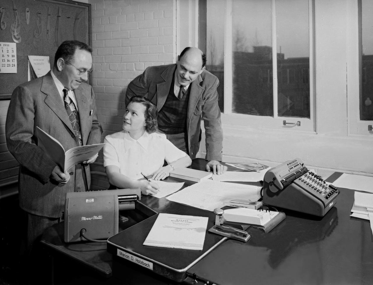 NACA Laboratory Computers Help Compile Handbook: ''Monroe Methods for Algebra, " a new booklet describing short-cuts that can be used in solving frequently-used algebraic formulas with a calculating machine, is undergoing its first trial at the hands of Laboratory computers. Several Monro-matics were purchased recently by NACA.  NACA Air Scoop August 17,1951 Page 4.  People on the photos re W.H. Rankins, David M. Goldenbaum and Marian D. Holzbach 