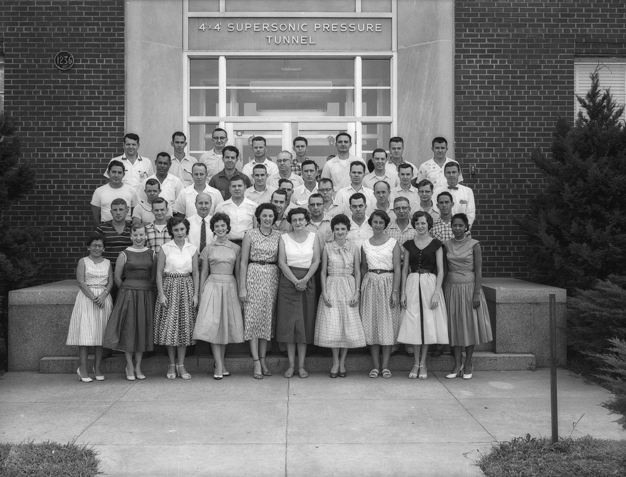 This photograph was taken August 15, 1956.  Mary Jackson first person in the front row right side.  Mary Jackson began at Langley in 1951 as a computer.  She was later assigned to work at the 4-Foot by 4-Foot Supersonic Pressure Tunnel where she worked with Kazimierz "Kaz" Czarnecki, who encouraged her to become an engineer.  To attend the university extension engineering classes held at the then all-white Hampton High School, Jackson was required to petition the courts, which she did successfully. The 4’ x 4’ Supersonic Pressure Tunnel was the NACA’s first supersonic wind tunnel. At the time of the photo, Mary Jackson was still a human computer, but was participating in the hands-on experimental work. Mrs. Jackson had begun her  studies to be an engineer in the Spring of the same year the photo was taken.  She obtained a degree in aerospace engineering in 1958.  Photo published in "A Century at Langley" by  Joseph R. Chambers page 74.